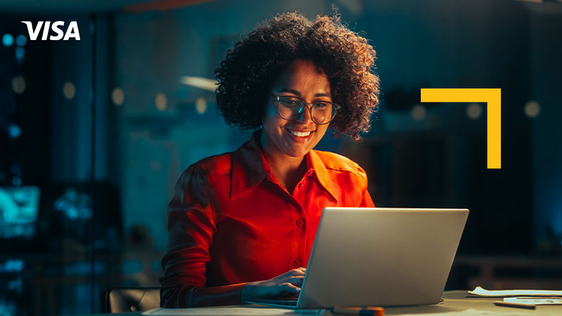 Woman working on a laptop late at night in an office